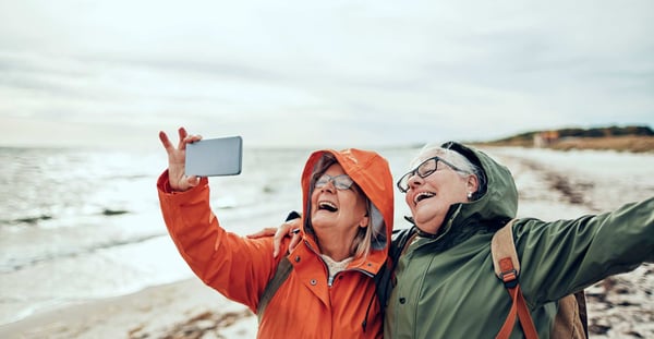 Two women laughing as they take a selfie