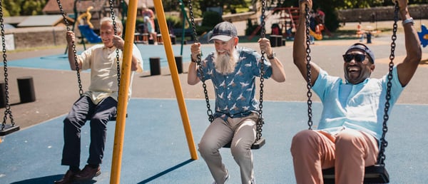 Group of Senior Men on Children Swings
