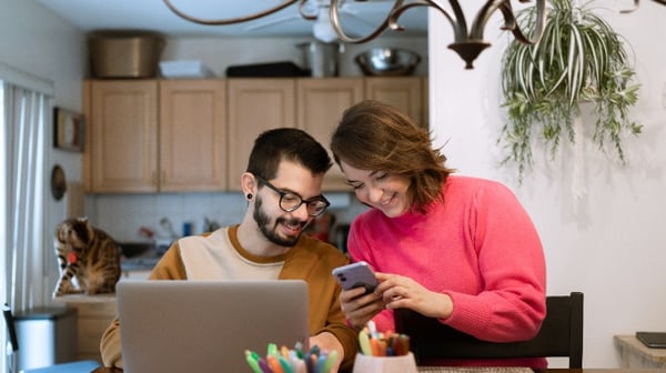 Image of a couple sitting at a laptop