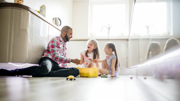 life cover - resources - img - Family life insurance - Father playing with daughters in kitchen - 730x411