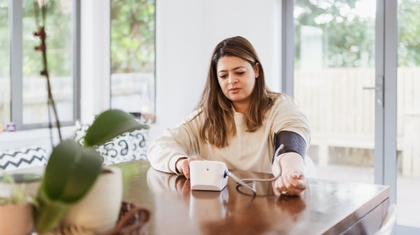 Lady taking her blood pressure at home