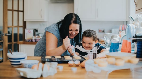 Mother cooking with young son