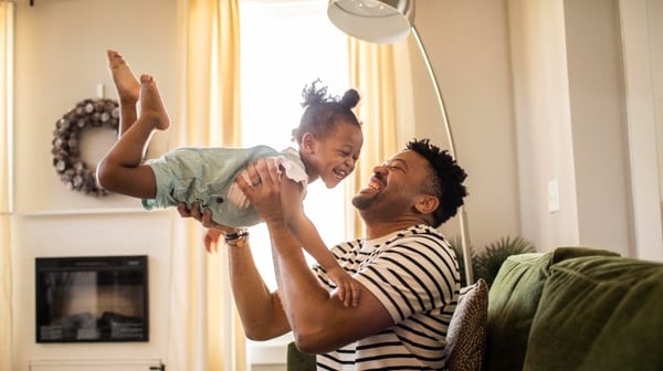 Father playing with young child