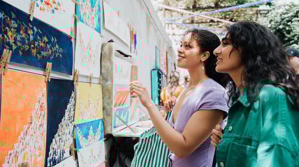 Two women looking at artwork