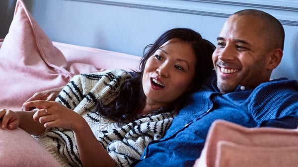 Couple laughing on sofa
