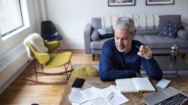 Mature man looking at paperwork