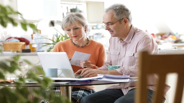senior couple looking at laptop