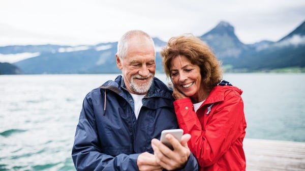 Senior couple talking with mobile phone