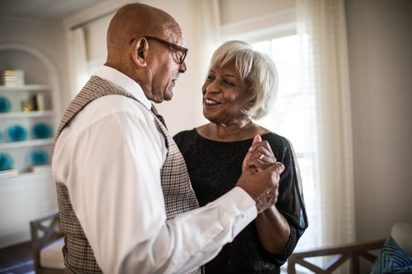 Senior couple embracing with hands