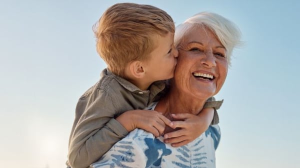 Grandmother smiling holding grandson